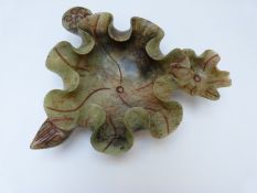 A Chinese jadeite style bowl in the form of a lotus leaf,
