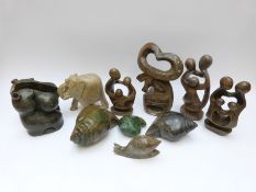 A large collection of carved Shona figures including some signed by Nick Mwanza,