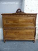 A French walnut bed with carved decoration comprising headboard,