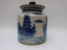 A large Chinese covered ginger jar with blue and white decoration of figures and a walled city