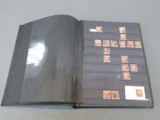 A stockbook of Victorian GB stamps including 1d red brown (large quantity), 1d red star,