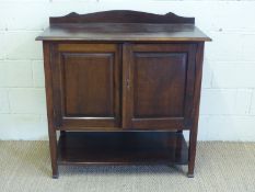An early 20thC cupboard with shelf below,