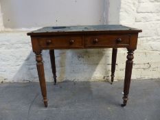 A 19thC two drawer mahogany desk in the manner of Gillows with reeded legs terminating in brass
