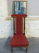 A Victorian upholstered Prie Dieu chair with gilt decoration and a painting of the chair