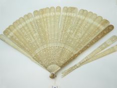 A 19thC Chinese Canton carved ivory fan depicting pagodas, flowers and birds,