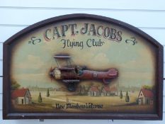 A wooden Captain Jacobs Flying Club sign,