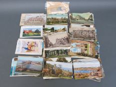 A collection of over 100 postcards, Edwardian era onwards, some stamped and scripted.