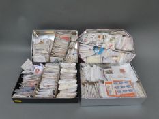 A large quantity of loose GB and Canada stamps in packets and tins