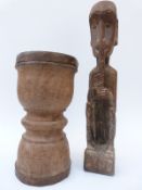 A carved wooden African figure, 55cm high and a turned wooden pedestal bowl,