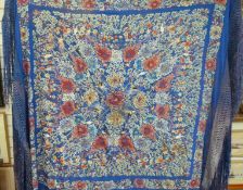 A 19thC / 20thC Chinese silk shawl embroidered with floral,