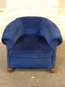 An early 20thC blue upholstered tub chair