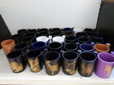 Thirty-three Portmeirion Zodiac and Portmeirion Village Imperial tankards in assorted colours