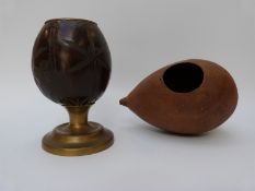 A 19thC carved coconut cup with brass mounts and carved gourd