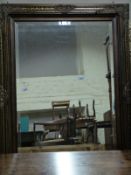 A pair of part gilt framed mirrors with bevelled edges,