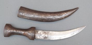 An Indo-Persian dagger with etched leaf decoration to blade in metal covered leather sheath,