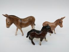 Two Beswick donkeys and a Beswick Shetland pony,