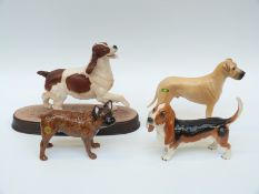 Four Beswick dogs to include Great Dane, Springer Spaniel,