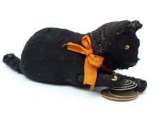Clockwork tinplate cat and caged mouse with black fur and orange bow, 18cm long.