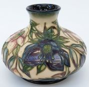 Moorcroft vase of squat form in Hellebore pattern, 10cm tall,