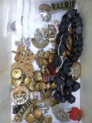 A collection of military badges and buttons including Royal Munster, East Sussex, Dorset,