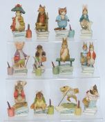 Twelve Beatrix Potter figures in boxes