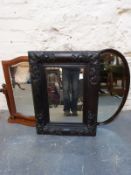 Three mirrors including one oval with bevelled glass and another in carved wooden frame