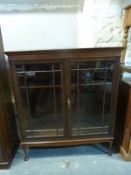 A mahogany bookcase with glazed door raised on short cabriole legs W110 x D36 x H125cm