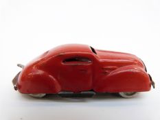 Miniature Lines Bros Minic clockwork tinplate car with red body and metal wheels