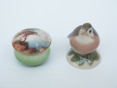 A Royal Worcester lidded pill pot decorated with a painted coastal scene and a Copenhagen bird