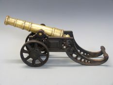 A cast iron brass barrelled signalling or similar cannon with 11.
