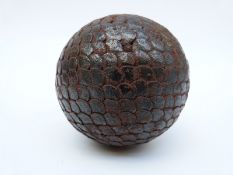 An antique boulle ball with overlapping hammered nail decoration, 8.