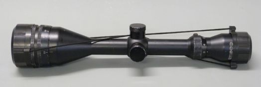 Tasco AG3-9x50WA rifle scope with lens covers.