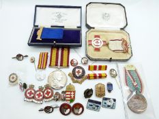 A collection of enamelled Red Cross badges,