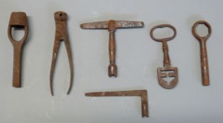 Six various cartridge or percussion gun tools including a T-shaped nipple wrench/ key and nipple