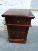 A bedside chest of three drawers,