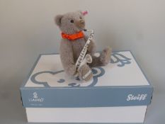 Steiff for Lladro musical teddy bear with grey mohair, ceramic saxophone, red ribbon,