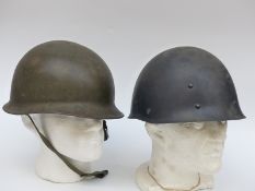 Post WWII German helmet complete with liner and chin strap together with a light weight helmet
