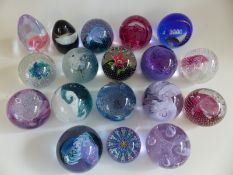 Seventeen Caithness Glass paperweights comprising Tidal Wave, Flower in the Rain, HM Queen Mother,
