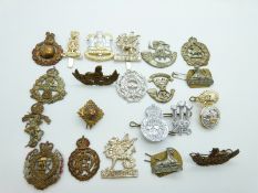 A small collection of cap badges including Herefordshire Light Infantry