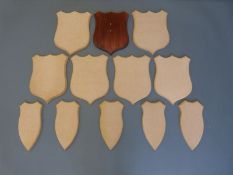 Twelve wooden taxidermy shield shaped mounts in two sizes, 33x26 and 30x15cm.