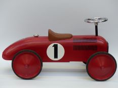 A child's scoot along sit on racing car with racing number 1, 75cm long.