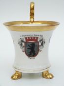 A Hutschenreuther 1936 Olympics commemorative footed cup with gilded loop handles