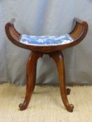 A rotating mahogany piano or dressing table stool