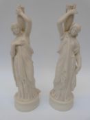 A pair of parian ware figures of water carriers,