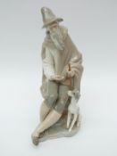 A Lladro figure of a man with a dog