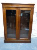A mahogany two door glazed book or display cabinet W92 x D31 x H123cm