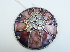 A hallmarked Scottish silver circular brooch/ pendant by Alastair Norman Grant set with blue,