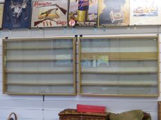 A pair of wooden train or model display cabinets with sliding glass doors and removable shelves,