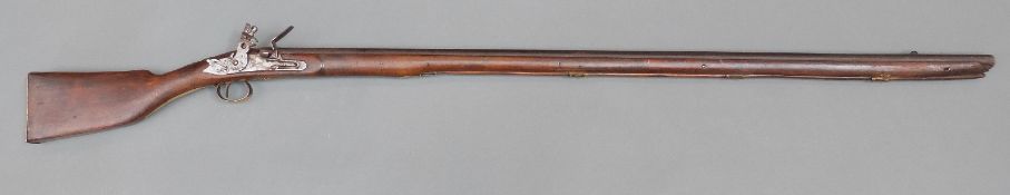 Flintlock hammer action gun with brass trigger guard, butt plate and mounts, wooden ramrod,