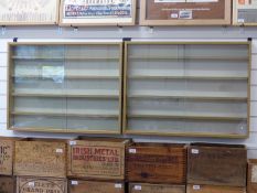 A pair of wooden train or model display cabinets with sliding glass doors and removable shelves,